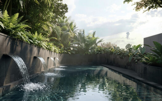Modern pool with cascading water features along a dark stone wall, surrounded by dense tropical plants and a bright sky.