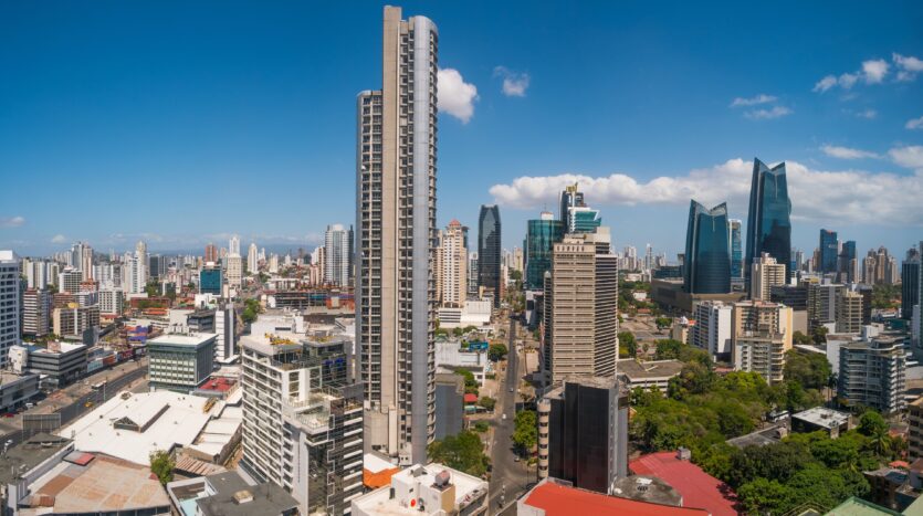Panoramic city skyline with numerous high-rise buildings under a clear blue sky during daytime